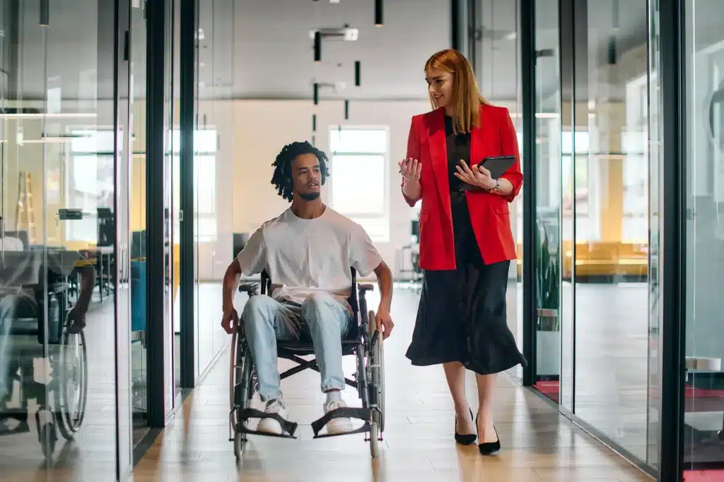 Business woman with colleague in wheelchair