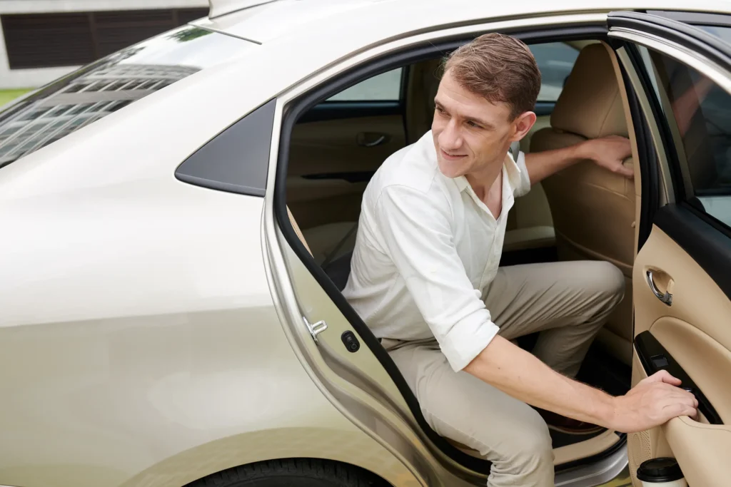 Businessman opening the cardoor and getting out