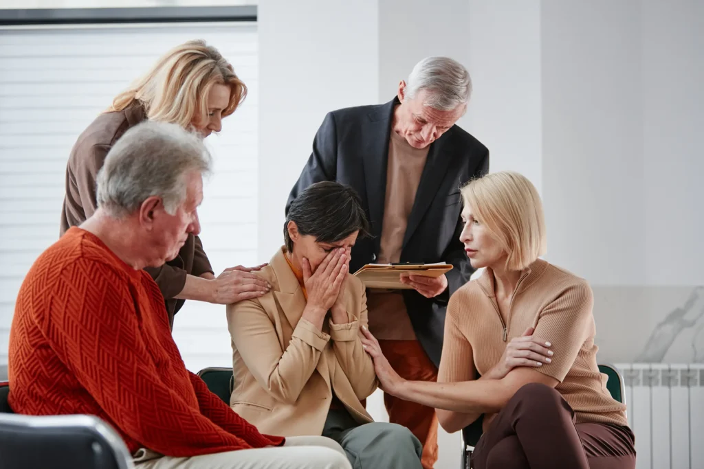 People supporting crying person