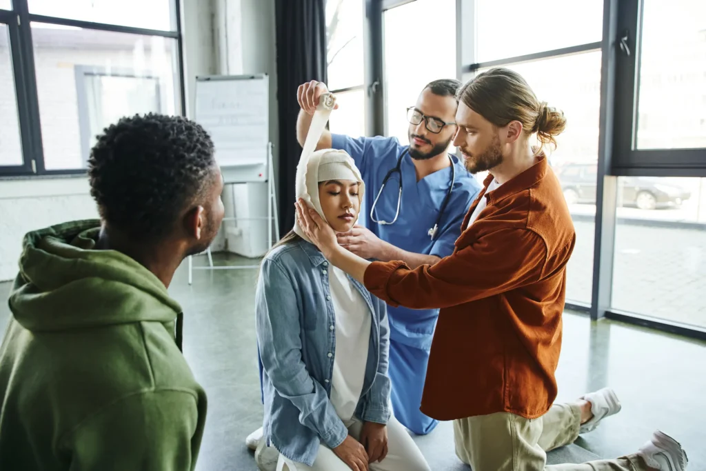 Medical instructor bandaging head