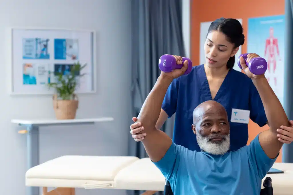 physiotherapist helping senior